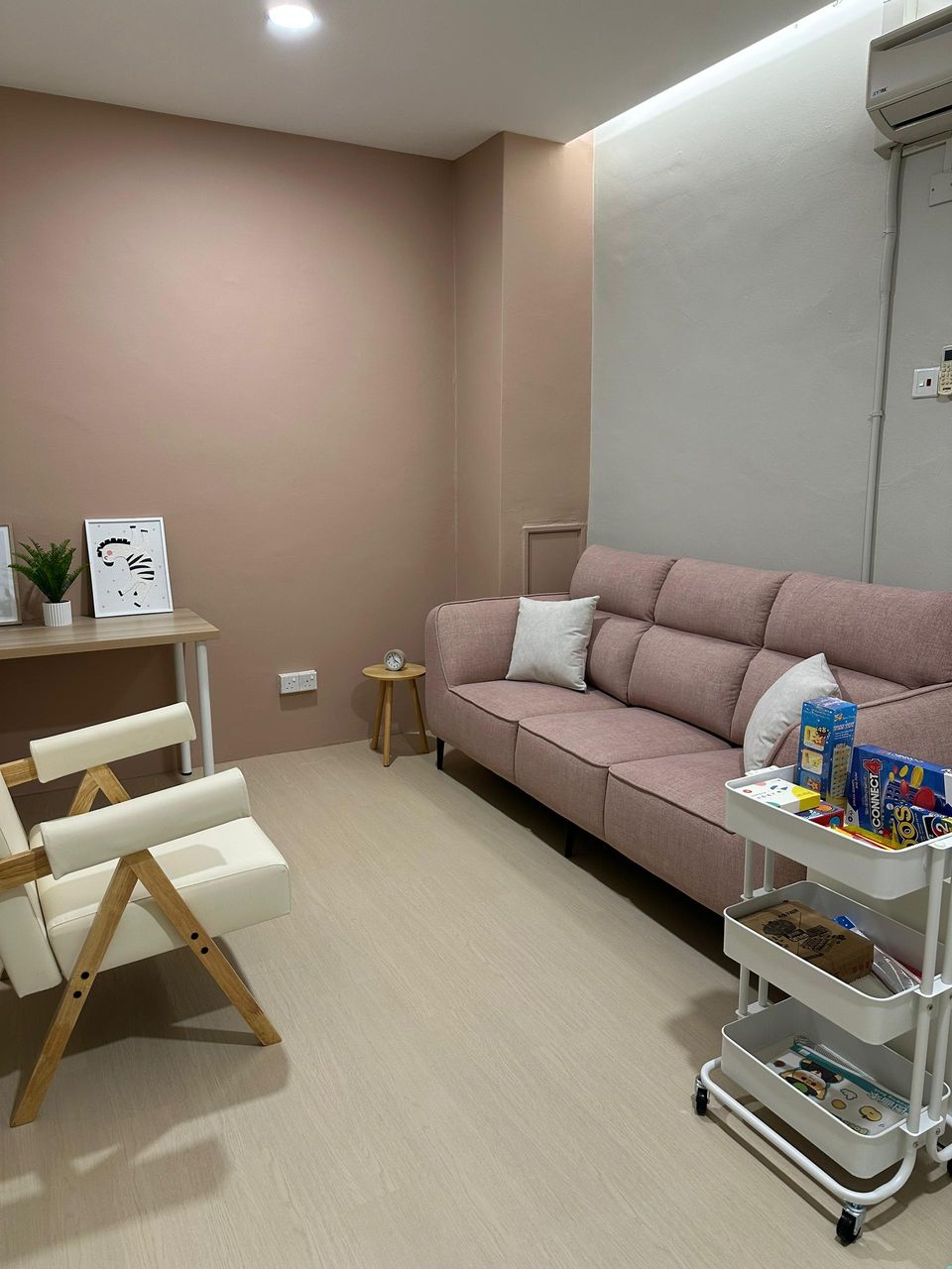 The Family Room sofa with an armchair and a cart of toys