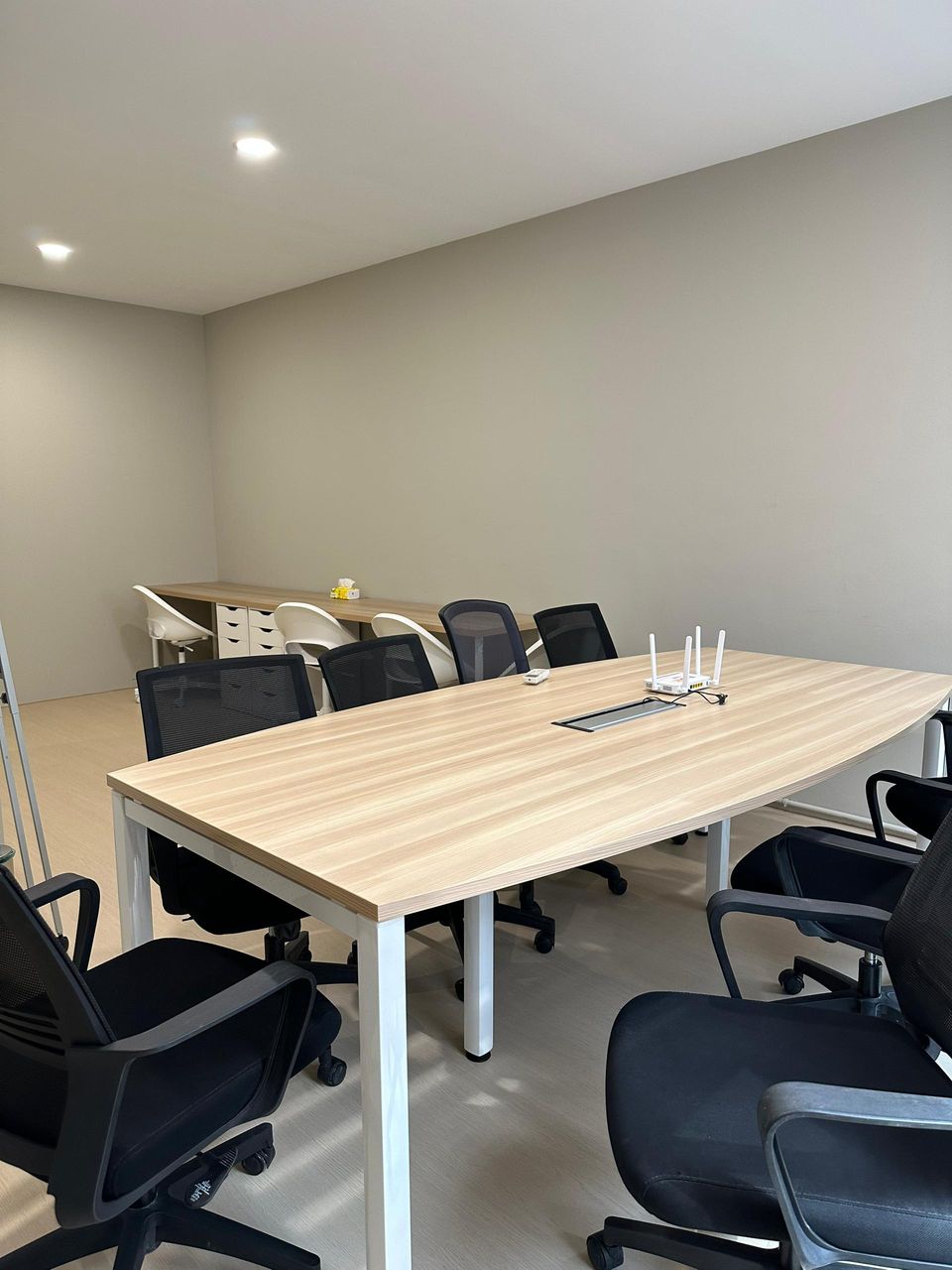 The Meeting Room, with a long table and black office chairs